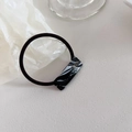 Detail of black elastic hair tie with marble texture acetate square and gold Handmade logo - Black and White Pattern