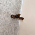Detailed macro view of a tortoiseshell bow hair clip with France Handmade engraving - Glazed Glass