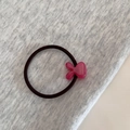 Close-up of pink rabbit ear hair tie with gold France Handmade text and black elastic - Rose Red