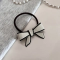 Close-up of black and white acetate bow hair tie with premium elastic band detail - White Scrunchie