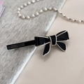 Detail of handmade acetate bow hair clip in black and white with gold lettering - Black Spring Clip