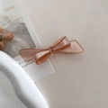 Detail of amber acetate bow hair clip with Barrette La France gold engraving - Orange