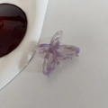 Macro detail of purple marble acetate butterfly hair claw with hollow bow design - Light Purple