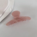 Close-up of pink acetate hair claw clip with marble texture and gold lettering detail - Pink