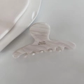 Detail of marbled white acetate hair claw clip featuring golden Barrette La France text - White