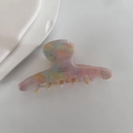 Close-up of acetic acid hair claw clip with marble texture and Barrette la France text - Pink Multi