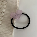 Close-up of a pink heart-shaped hair tie with marble texture on white knit background - Light Pink