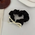 Detail of elegant black satin hair scrunchie featuring a white minimalist metal bow - Off-white