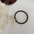 Detail showing high-elasticity rubber hair tie with handmade acrylic bow ornament - Mermaid White