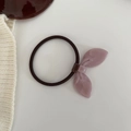 Detail shot of a pink acrylic leaf charm on high-elasticity hair tie with handmade gold label - Light Purple