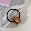 Elastic hair tie with amber resin square charm and gold heart detail in black - Cube / Brown