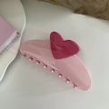 Detail of pink heart hair claw clip with glossy finish resting on a ceramic plate - Heart Hair Claw / Pink