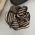 Macro shot of French style striped satin scrunchie with detailed stitching and soft pleats - Brown Stripes