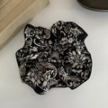 Close-up of a large black vintage paisley pattern satin scrunchie on a white background - Black Paisley