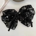 Detalle de coletero de lazo en tul con lunares negros y hebilla de metal dorado - Pinza De Lunares Con Lazo Negro