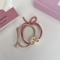 Close-up of pink and grey elastic hair ties featuring decorative fruit and text beads - Pink Series - Because Of You