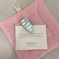 Light blue mermaid pearl hair clip with fluid wave texture on aesthetic card - Water Drop Style / Holographic Blue