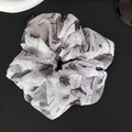 Close-up of a black and white ink floral pattern on a soft pleated chiffon scrunchie - Hair Tie / White