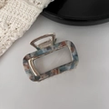 Macro shot of marble textured acetate hair claw clip with strong silver metal spring - Royal Blue