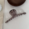 Detail shot of the minimalist translucent grey hair claw clip with its elegant hollow design - Transparent Gray