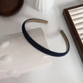 Detail of slim denim headband showing blue fabric texture on a ceramic cup display - Slim Black