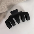 Macro detail of large matte black hair claw clip for thick hair on minimalist background - Black