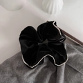 Macro-opname van zwarte fluwelen scrunchie met witte rand op grijze stoffen ondergrond - Middelgroot / Zwart