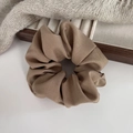 Close-up detail of a brown ruffled scrunchie with soft fabric texture on a neutral background - Khaki
