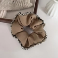 Detailed close-up of brown scrunchie with fringe edges on a wooden tray background - 1# Khaki