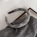 Detail of grey plaid padded headband showing handmade label on a soft textured fabric - Premium Grey