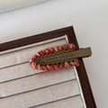 Detail view of ethnic hand-woven crochet trim on army green matte metal hair clip - Light Coffee