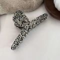 Detail of dalmatian print acetate hair claw clip on a warm aesthetic background - Polka Dot