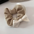 Detailed view of checkered scrunchie with large satin bow in warm khaki and cream - Solid Waffle Style