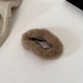 Detail of plush light brown cloud-shaped hair clip with metal base on knit background - Light Camel