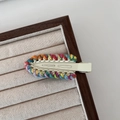 Rainbow hand-woven crochet hair clip with a cream base and colorful spiral yarn pattern - Off-white