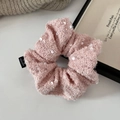 Detailed view of pink sequin tweed scrunchie with soft knit texture on white background - Pink