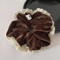 Detail of vintage brown velvet scrunchie with white lace edges and a small woven label - Brown