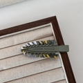 Knitted hair clip with grey white and yellow yarn on army green matte metal base - Grey Green
