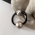 Detailed macro view of black high-elastic hair tie with pearl bead and metal smiley charm - 3# Silver