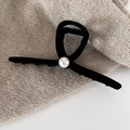 Close-up of elegant black velvet bow hair claw clip with a single white pearl accent - Small Pearl Grab Clip