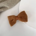 Detail of soft brown knitted bow hair clip with textured ribbed wool and satin ribbon - Coffee