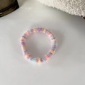 Detailed macro view of colorful plush hair tie with macaron tones and pink bead - Light Powder Blue