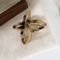 Schildpatt Schmetterling Haarklammer mit goldener Metallfeder auf Stoffhintergrund - Helles Leopardenmuster
