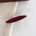 Macro view of a deep red oval resin hair clip with elegant gold handmade lettering - 6#Vintage Red