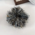 Macro detail of mixed color chunky knit scrunchie with soft fuzzy texture and fibers - Dark Green
