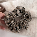 Detailed view of houndstooth scrunchie with flocking bowknot and autumn fabric texture - Coffee Plaid Bow
