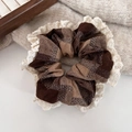 Detail of hazelnut brown plaid hair scrunchie with lace trim on a beige sweater - Coffee Plaid