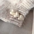 Macro shot of three cream heart hair clips with golden Handmade France logo on fabric - French Handmade Heart Duckbill Clip / Cream White