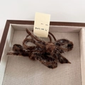 Detail of chocolate brown leopard faux fur bow hair tie with shimmering silver glitter thread - Dark Leopard Scrunchie