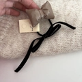 Detail of coffee patent leather bow and black velvet ribbon hair clip on card - Khaki Bow Hair Tie